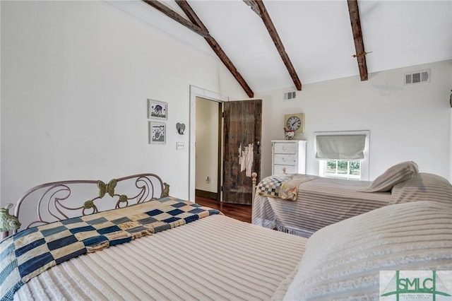 bedroom featuring vaulted ceiling with beams, wood finished floors, and visible vents