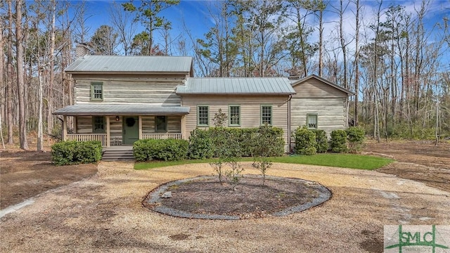 view of front of property featuring metal roof and a porch