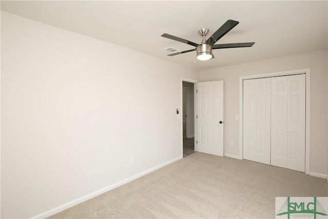 unfurnished bedroom with a ceiling fan, carpet flooring, visible vents, and baseboards