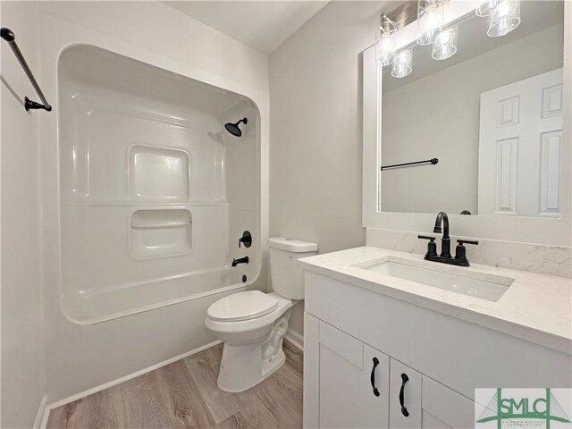 full bathroom with vanity, shower / tub combination, wood finished floors, and toilet