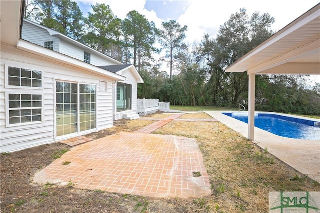 outdoor pool with a patio area