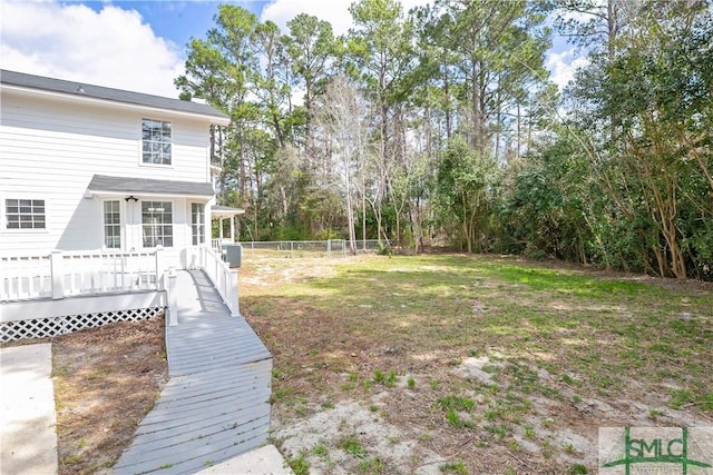 view of yard featuring fence and a deck