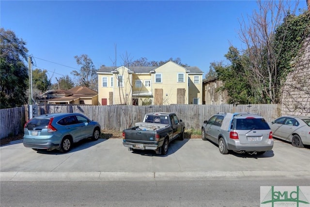 multi unit property featuring uncovered parking, fence private yard, and a residential view