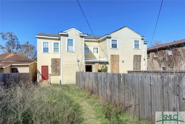 rear view of property with fence