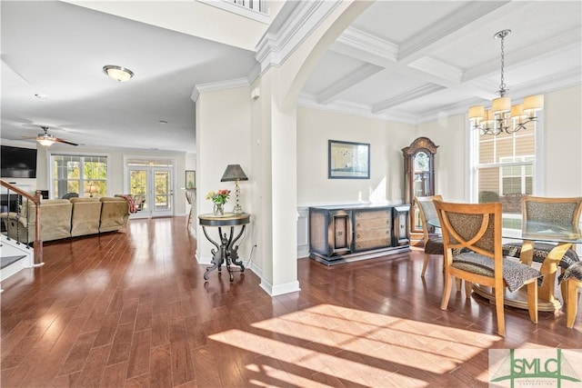 interior space with arched walkways, beam ceiling, coffered ceiling, and wood finished floors