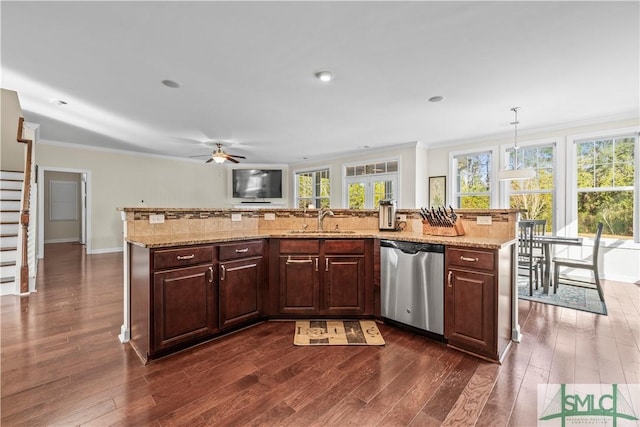 kitchen with a sink, a healthy amount of sunlight, ornamental molding, and dishwasher