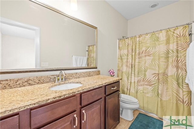 bathroom featuring toilet, tile patterned flooring, and vanity