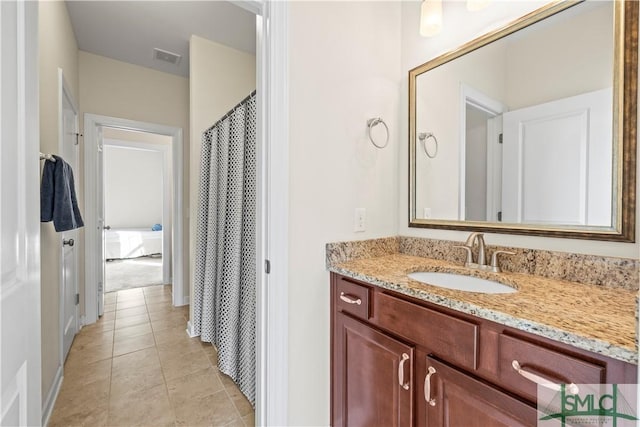 full bathroom with visible vents, vanity, and tile patterned floors