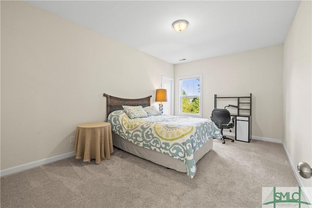 carpeted bedroom featuring baseboards