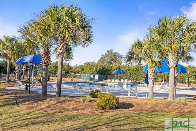 view of jungle gym featuring fence and a community pool