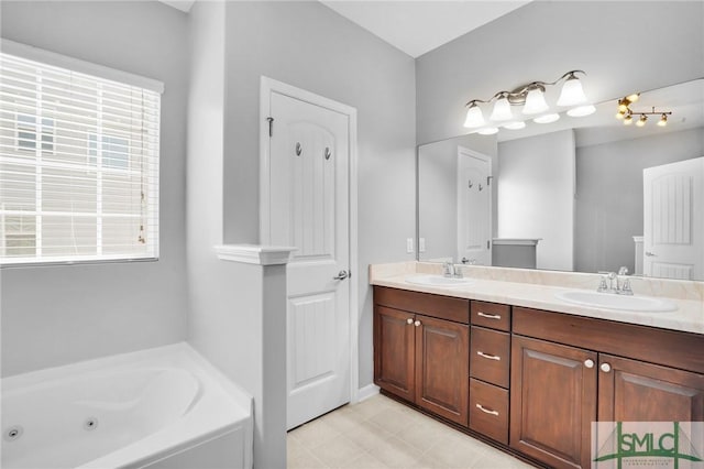 bathroom with a sink, a tub with jets, and double vanity