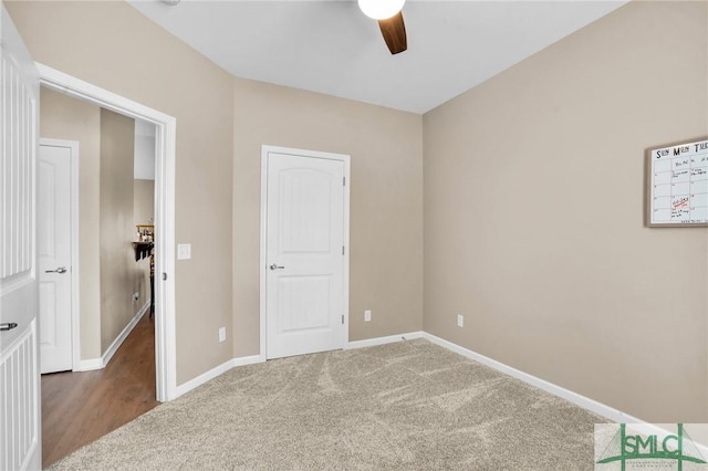 unfurnished bedroom featuring carpet flooring, a ceiling fan, and baseboards