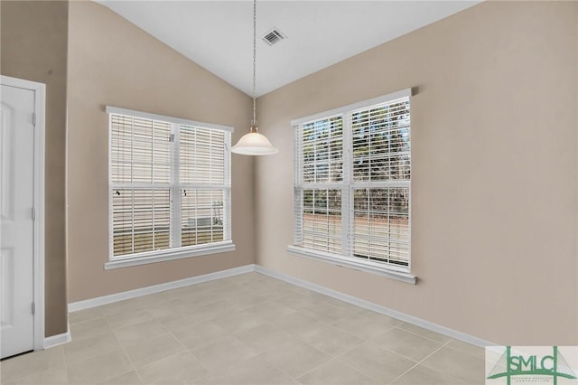 unfurnished dining area featuring visible vents, baseboards, and vaulted ceiling