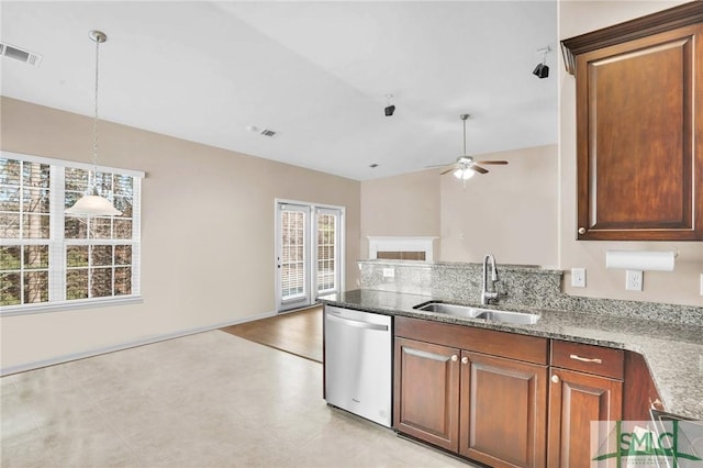 kitchen featuring visible vents, open floor plan, a peninsula, stainless steel dishwasher, and a sink