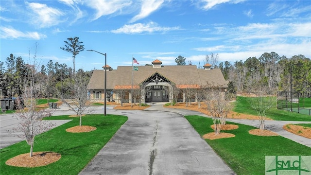 view of property featuring curved driveway