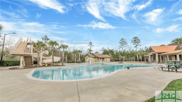 pool featuring stairway and a patio area