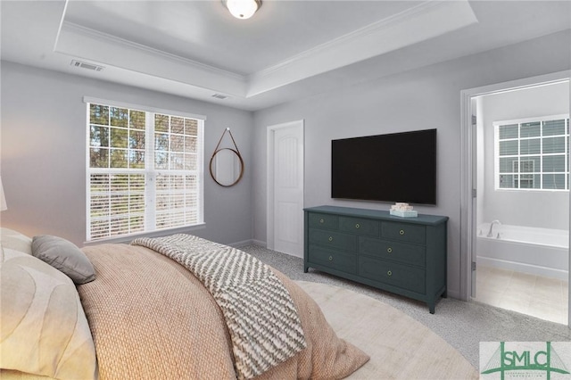 bedroom featuring light carpet, visible vents, and a raised ceiling