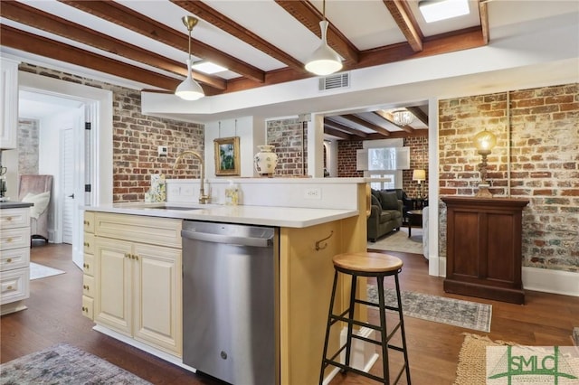 kitchen with dark wood-style floors, brick wall, a sink, and stainless steel dishwasher