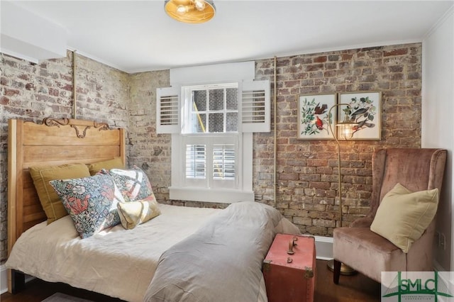 bedroom featuring brick wall