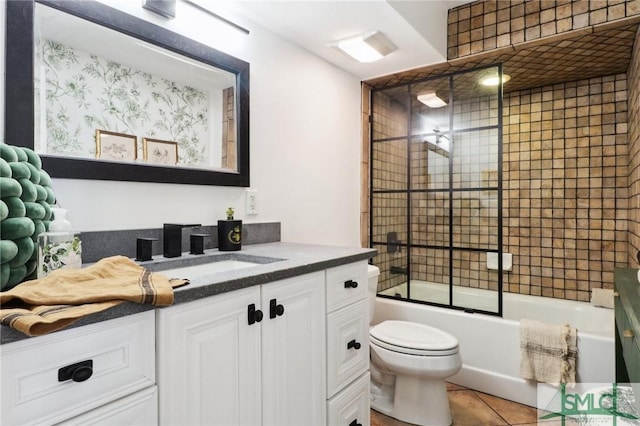 full bathroom with toilet, tile patterned flooring, enclosed tub / shower combo, and vanity