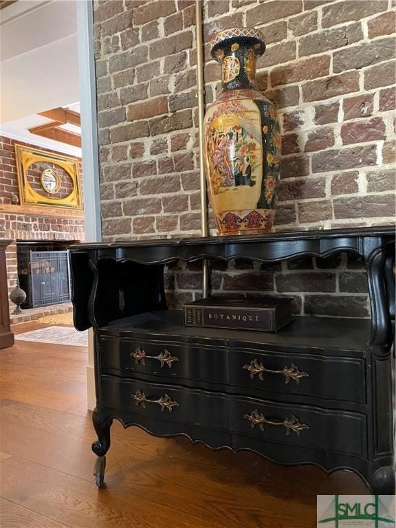 room details with a brick fireplace and wood finished floors