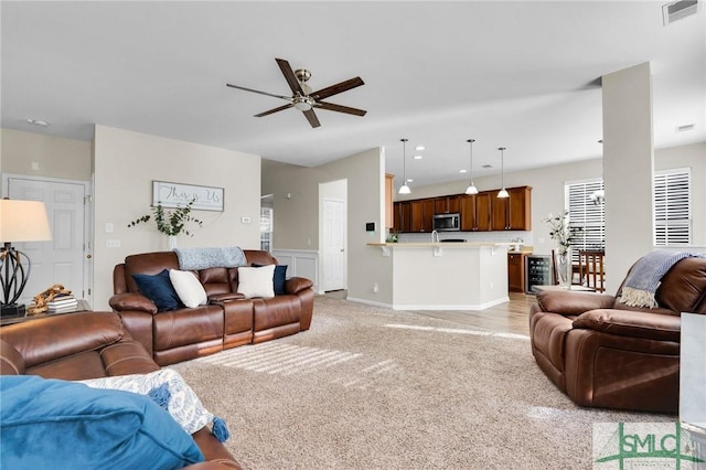 living area with visible vents, a ceiling fan, light colored carpet, wine cooler, and recessed lighting