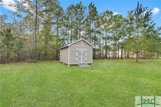 view of yard featuring a storage shed and an outbuilding