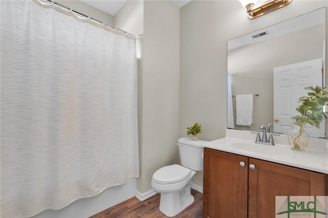 full bath featuring shower / tub combo, visible vents, toilet, wood finished floors, and vanity