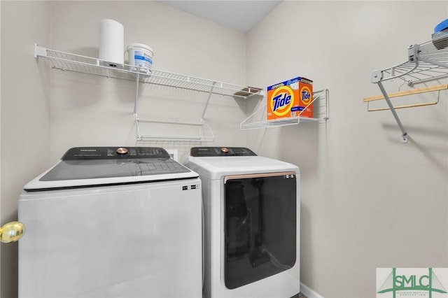 clothes washing area with laundry area and washer and dryer