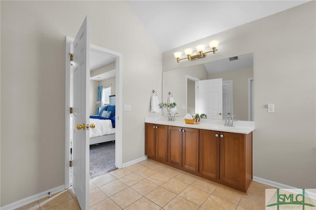 bathroom featuring double vanity, visible vents, lofted ceiling, ensuite bath, and tile patterned floors