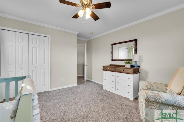 bedroom featuring baseboards, a ceiling fan, crown molding, carpet floors, and a closet