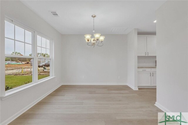 176 Orkney Rd, Savannah, GA 31407 - unfurnished dining area featuring baseboards, visible vents, light wood-style flooring, and an inviting chandelier