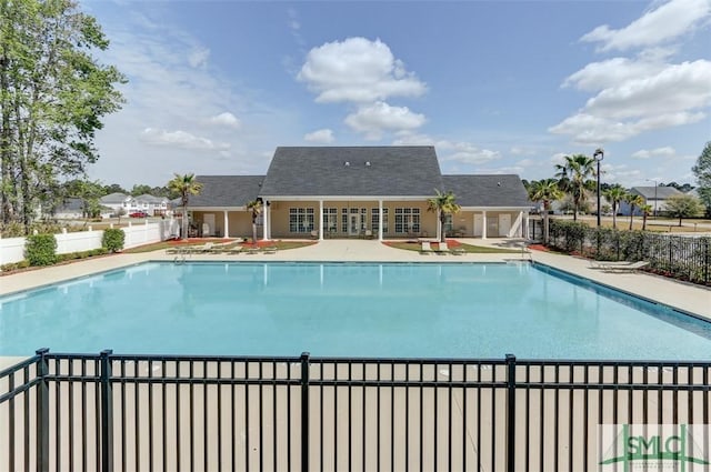 pool with a patio and fence