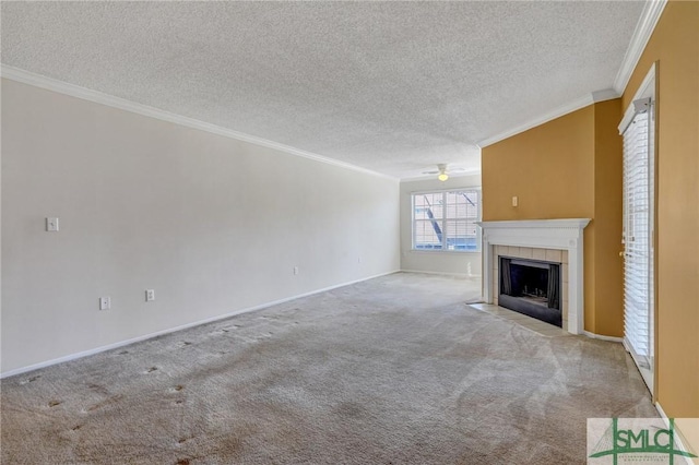 unfurnished living room with carpet, crown molding, a ceiling fan, a textured ceiling, and a tile fireplace