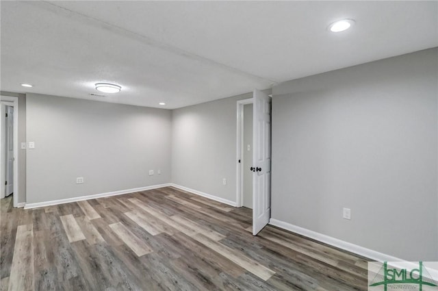 finished below grade area featuring baseboards, wood finished floors, and recessed lighting