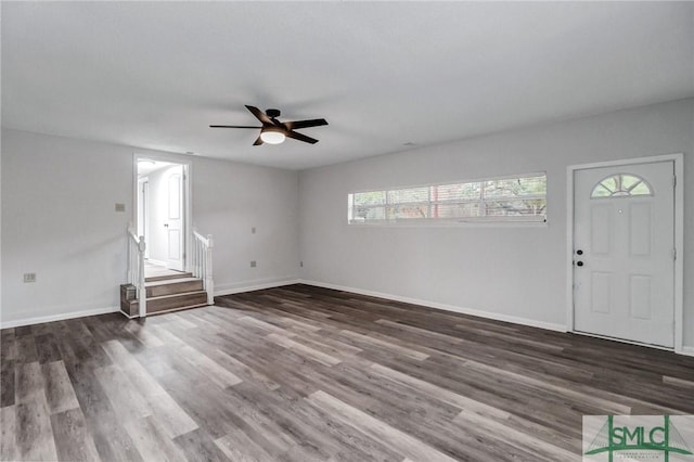 entryway with ceiling fan, stairway, wood finished floors, and baseboards