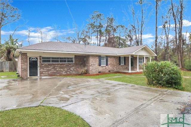 ranch-style home with concrete driveway, crawl space, fence, a front lawn, and brick siding