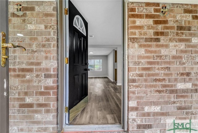 entrance to property with brick siding