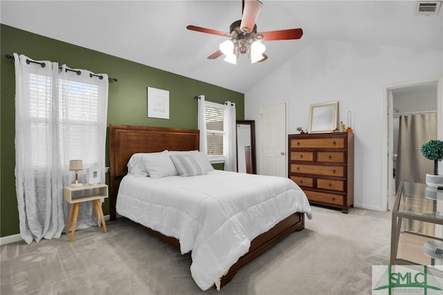 bedroom with light colored carpet, visible vents, a ceiling fan, vaulted ceiling, and baseboards