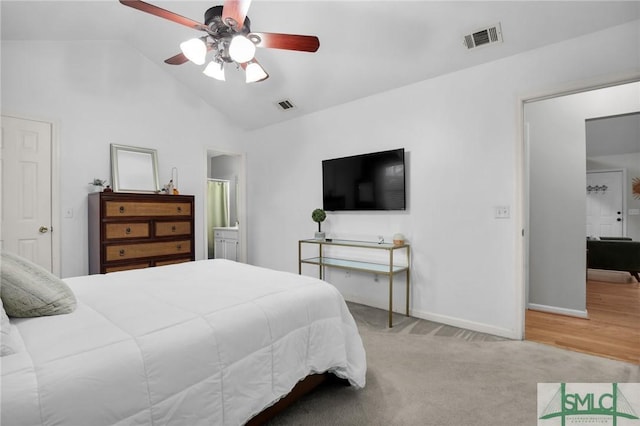 bedroom with vaulted ceiling, carpet, visible vents, and baseboards