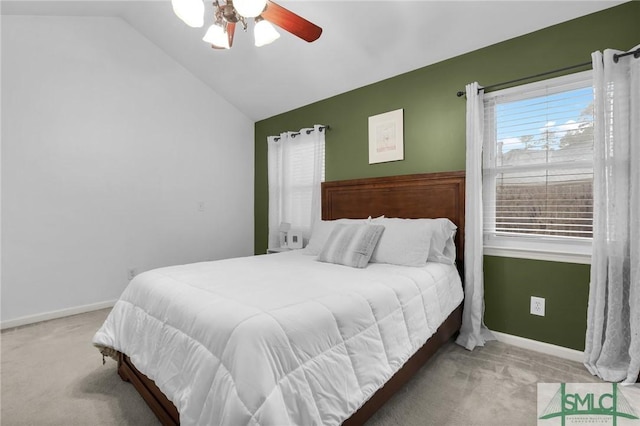 carpeted bedroom featuring baseboards, vaulted ceiling, and a ceiling fan