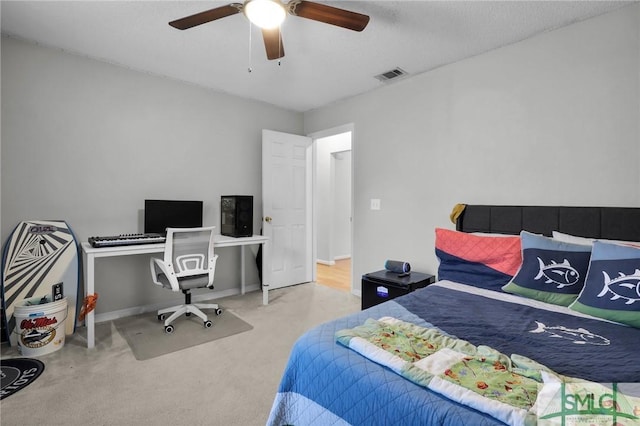 bedroom with baseboards, carpet floors, visible vents, and a ceiling fan