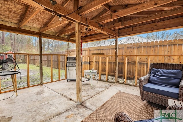 view of patio / terrace with a grill and fence