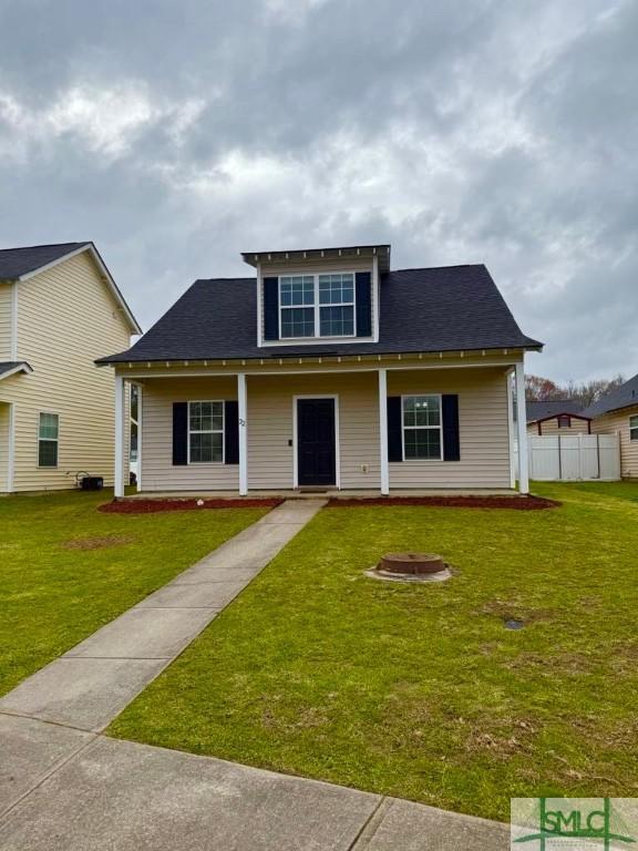 view of front of property featuring a fire pit, fence, and a front yard