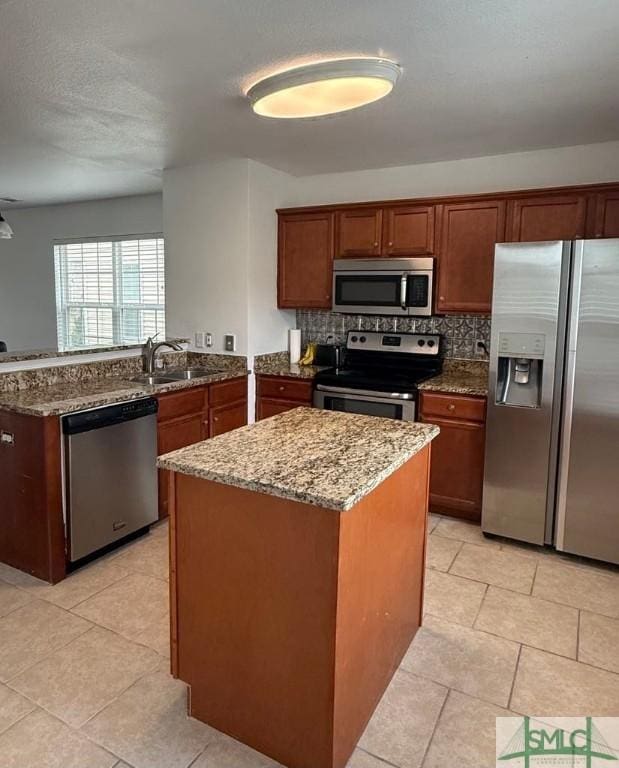 kitchen with stainless steel appliances, backsplash, dark stone countertops, and a sink