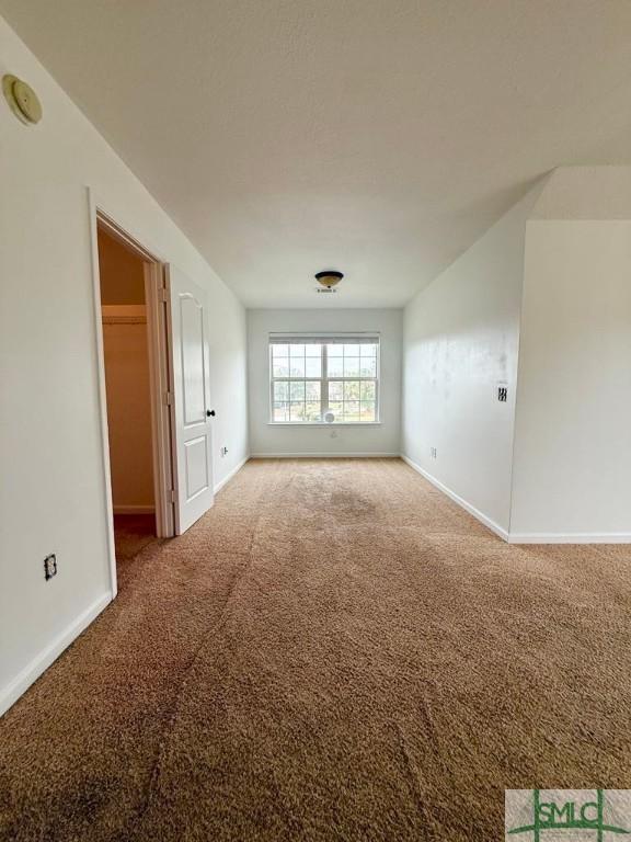 spare room with carpet flooring and baseboards