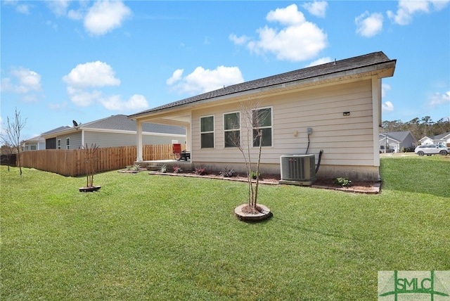 80 Rimmon Ct, Richmond Hill, GA 31324 - rear view of house featuring central AC unit, a lawn, and fence