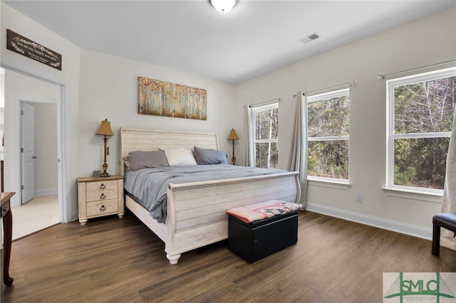 80 Rimmon Ct, Richmond Hill, GA 31324 - bedroom with dark wood-type flooring, visible vents, and baseboards