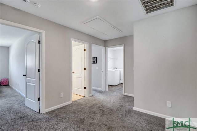 interior space with washing machine and clothes dryer, visible vents, attic access, carpet flooring, and baseboards