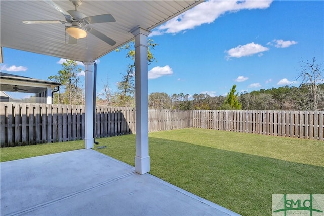 view of yard featuring a patio area, a fenced backyard, and a ceiling fan